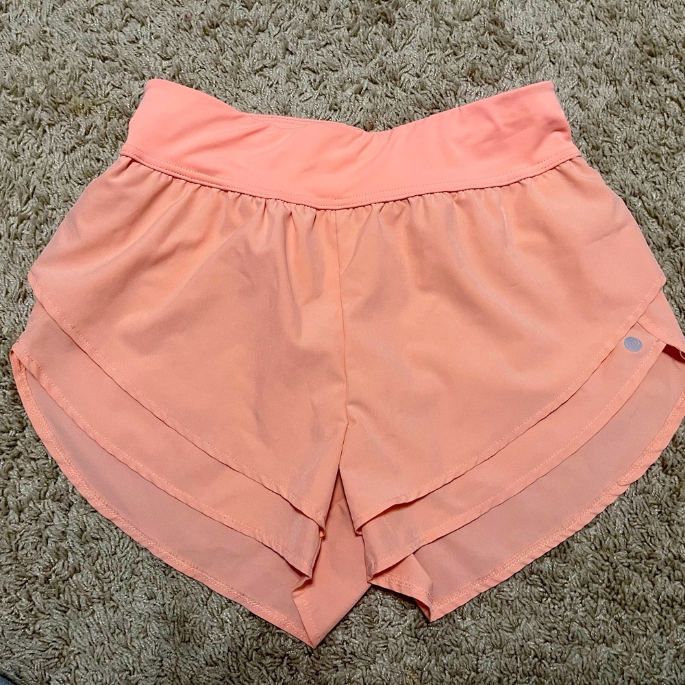 Orange-peach colored athletic shorts